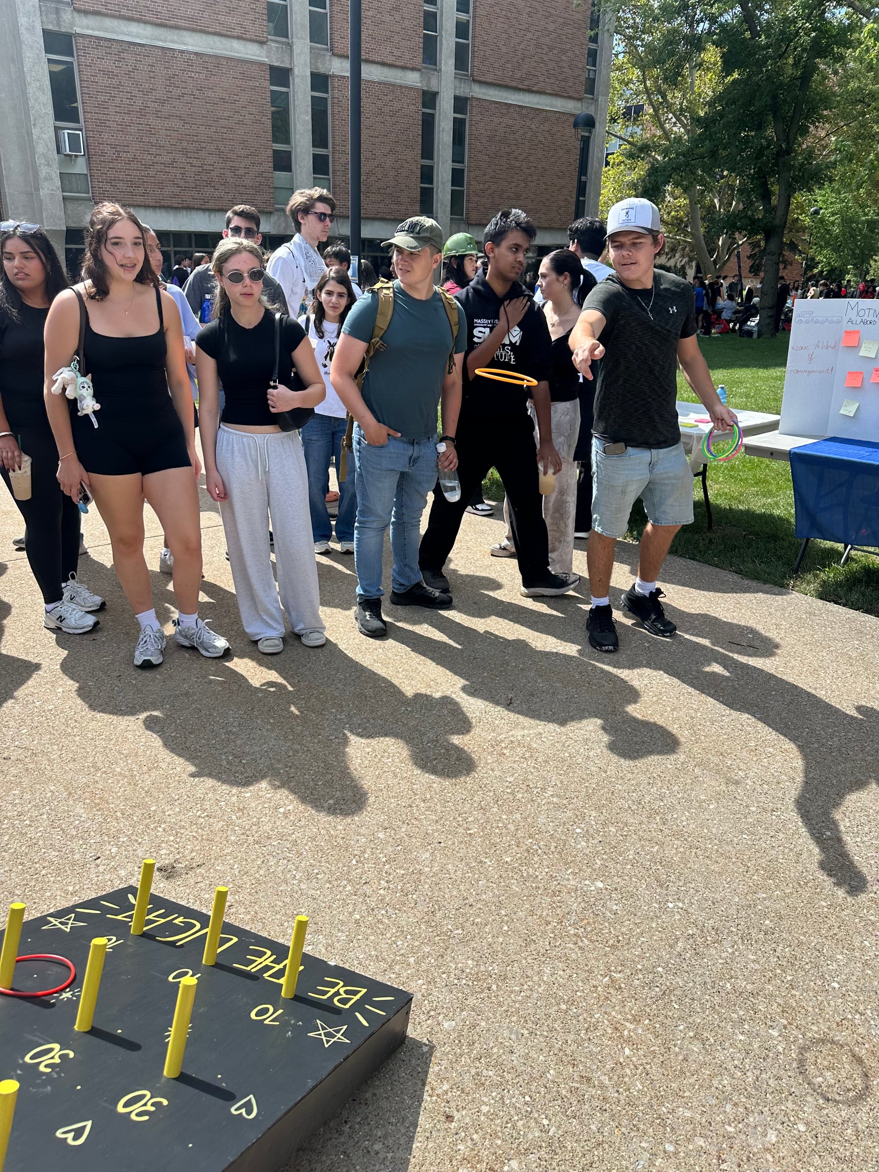 Students playing Light Toss at the Little Lights booth